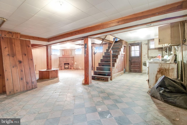 basement with wooden walls and a fireplace