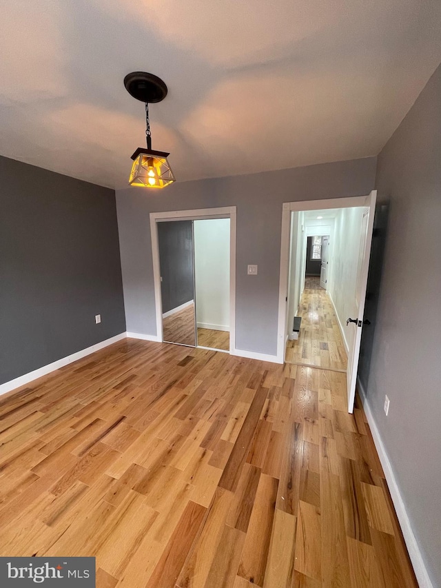 empty room with light hardwood / wood-style flooring