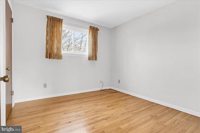 spare room with light hardwood / wood-style flooring