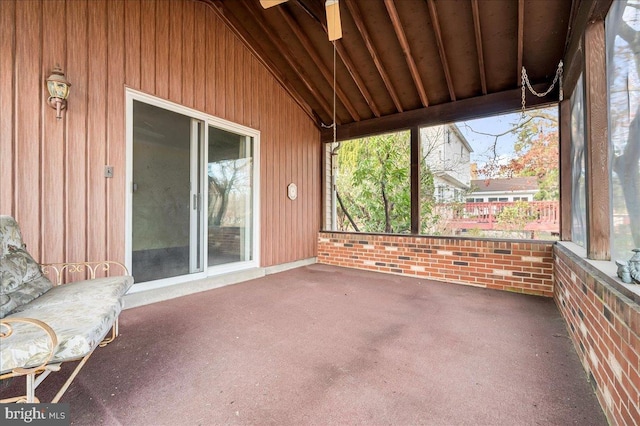 unfurnished sunroom featuring ceiling fan and vaulted ceiling