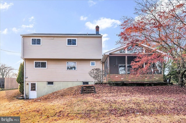 back of property featuring a sunroom