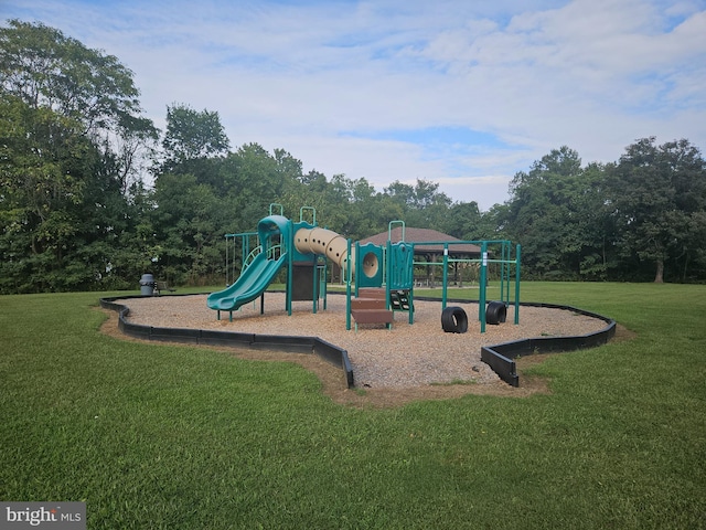 view of jungle gym with a lawn