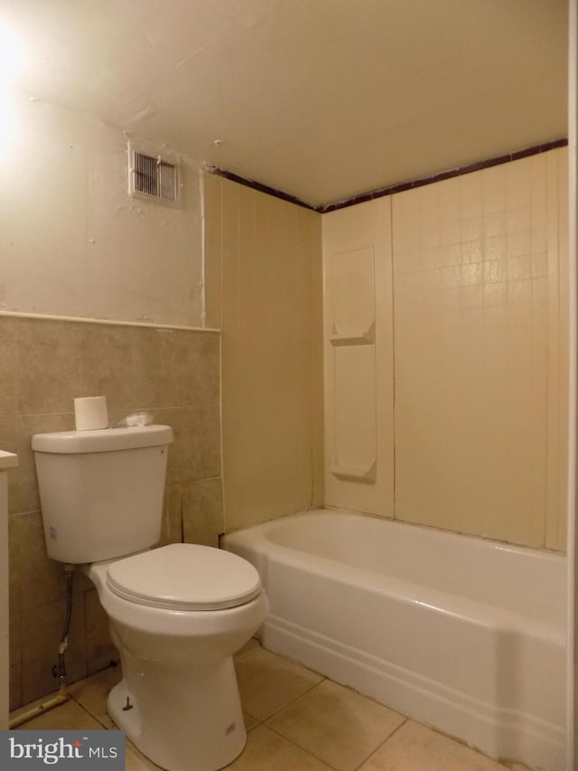 bathroom featuring tile patterned floors, tile walls, and toilet