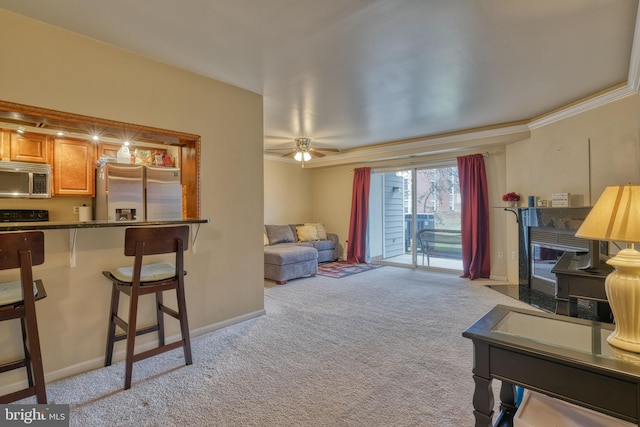 living room with crown molding, light colored carpet, and ceiling fan