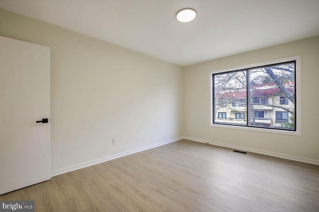 spare room featuring light hardwood / wood-style flooring