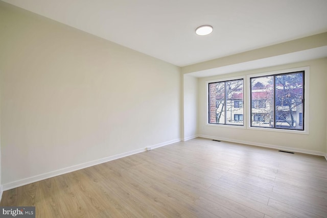 unfurnished room with light hardwood / wood-style floors