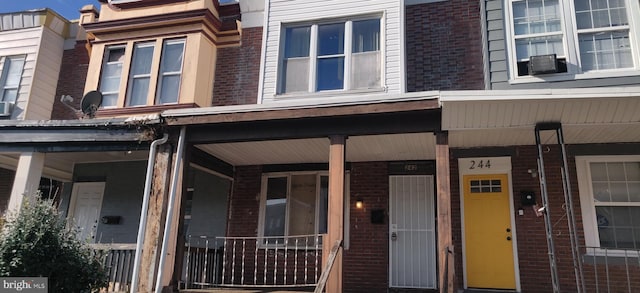 view of exterior entry featuring covered porch