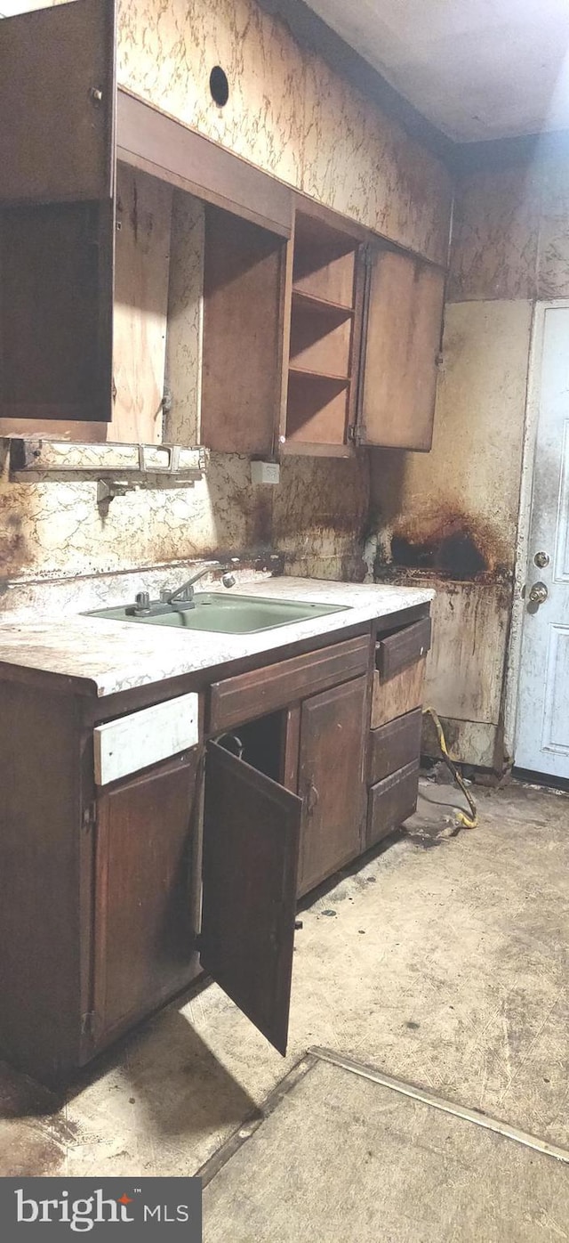 kitchen featuring dark brown cabinetry and sink