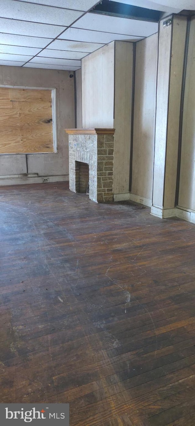 unfurnished living room featuring dark hardwood / wood-style floors and a fireplace