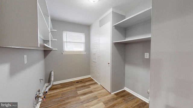 laundry room featuring light hardwood / wood-style floors