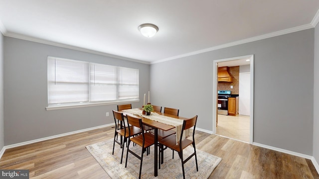 dining area featuring ornamental molding and light wood-type flooring