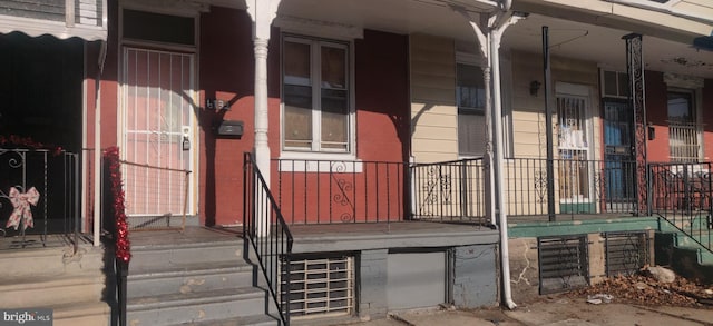 view of exterior entry featuring a porch