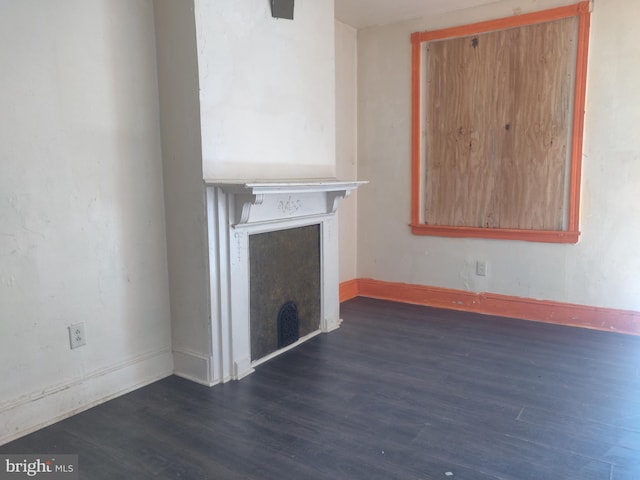 unfurnished living room with dark wood-type flooring