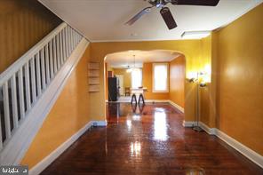 hallway featuring ornamental molding and dark hardwood / wood-style flooring