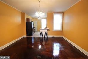 unfurnished dining area featuring a notable chandelier and wood-type flooring