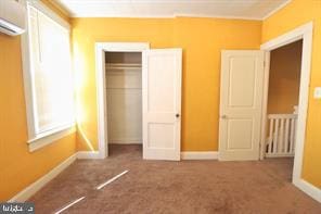 unfurnished bedroom featuring carpet flooring and a closet