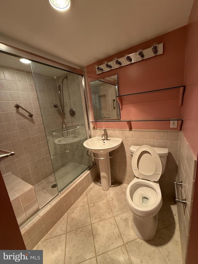 bathroom with toilet and a shower with shower door