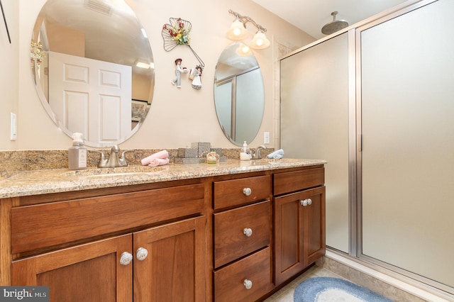 bathroom featuring tile patterned flooring, vanity, and an enclosed shower