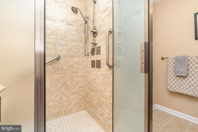 bathroom with tile patterned floors and a shower with shower door