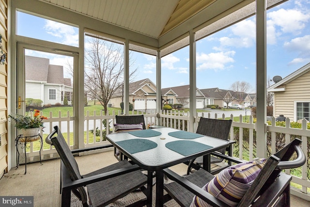 sunroom / solarium featuring vaulted ceiling