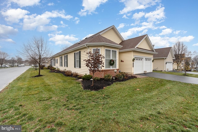 view of front of house with a garage and a front lawn