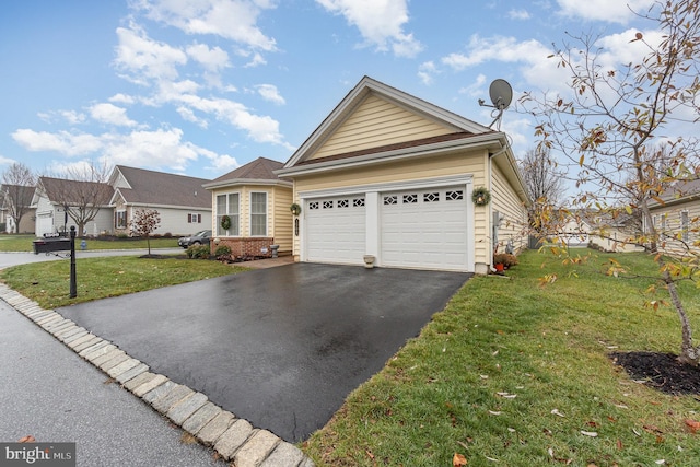 view of front of home with a garage and a front lawn