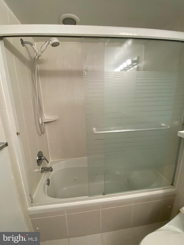 bathroom featuring toilet and enclosed tub / shower combo