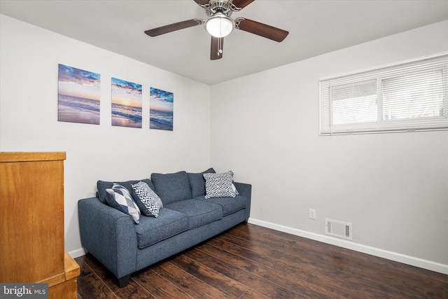 living room with ceiling fan and dark wood-type flooring