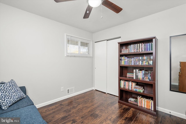 sitting room with dark hardwood / wood-style floors and ceiling fan