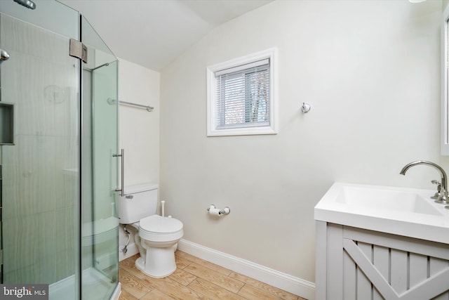 bathroom featuring hardwood / wood-style flooring, toilet, lofted ceiling, and walk in shower