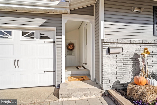 doorway to property with a garage