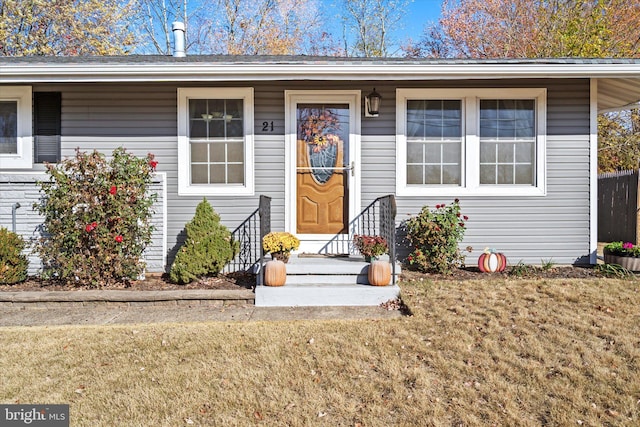 doorway to property with a yard