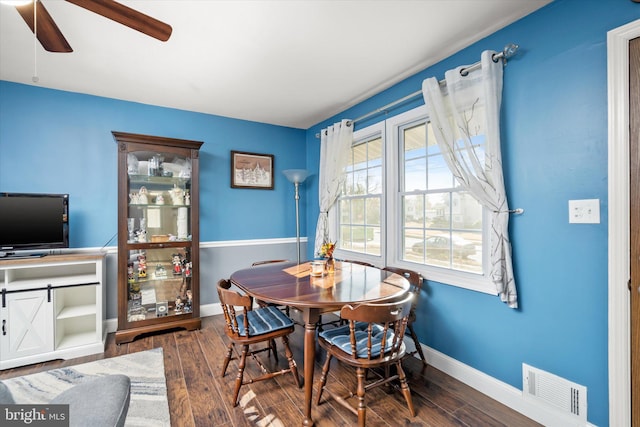 dining area featuring ceiling fan and dark wood-type flooring