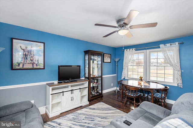 living room featuring ceiling fan and dark hardwood / wood-style flooring