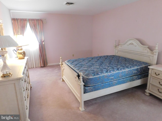 bedroom featuring light carpet