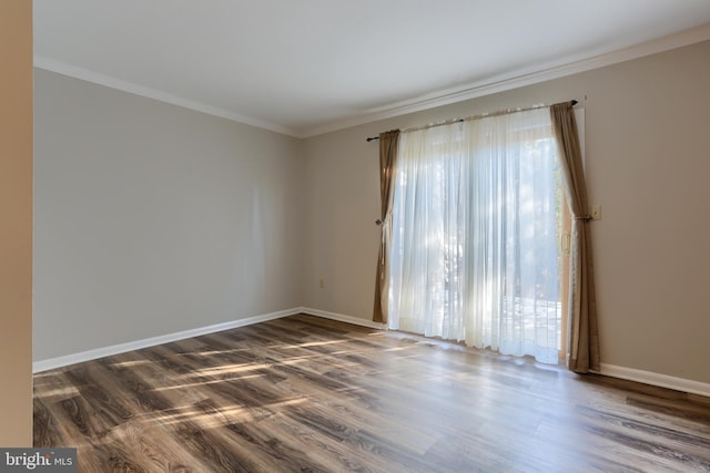 empty room with ornamental molding and dark wood-type flooring