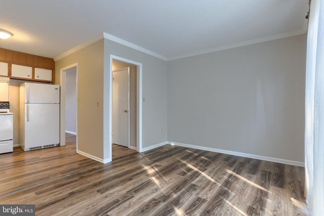 kitchen with dark hardwood / wood-style flooring, white appliances, and crown molding