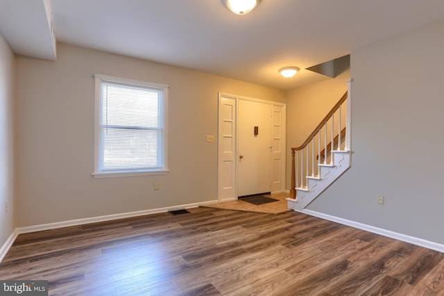 foyer entrance featuring dark wood-type flooring