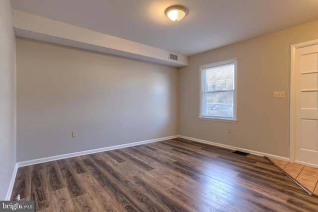 spare room featuring dark hardwood / wood-style flooring