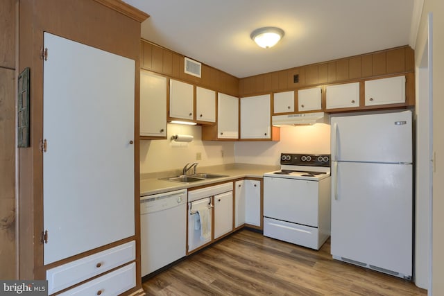 kitchen with light hardwood / wood-style floors, white appliances, sink, and white cabinetry