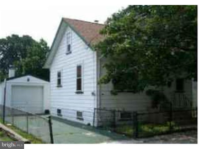 view of front of house featuring a garage and an outdoor structure