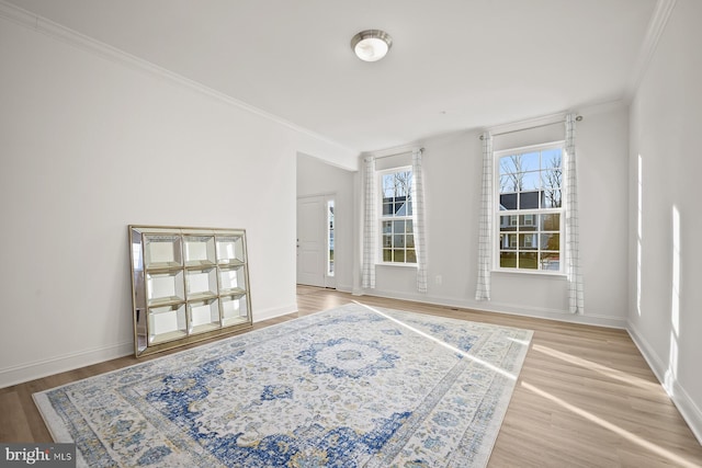 empty room featuring hardwood / wood-style flooring and ornamental molding