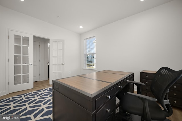 home office with light hardwood / wood-style flooring and french doors