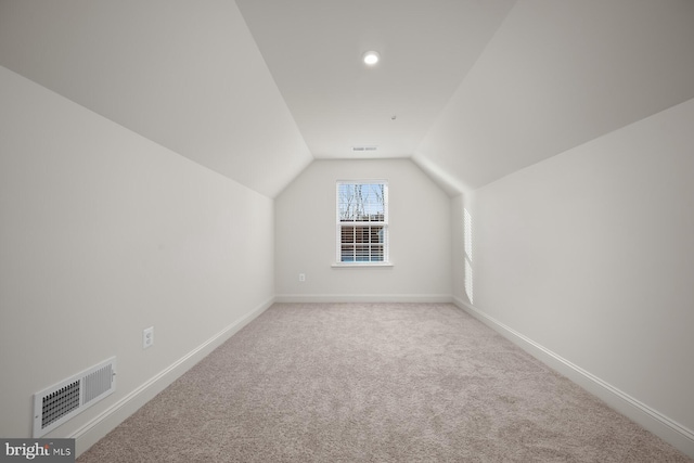 additional living space with light carpet and lofted ceiling