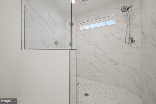 bathroom with tiled shower