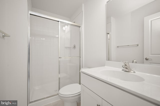 bathroom with vanity, an enclosed shower, and toilet