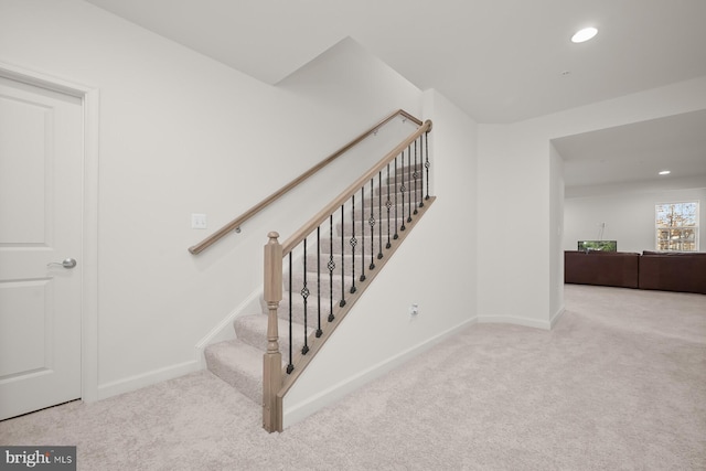 stairs featuring carpet flooring