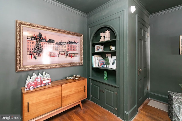 room details featuring ornamental molding, baseboards, and wood finished floors