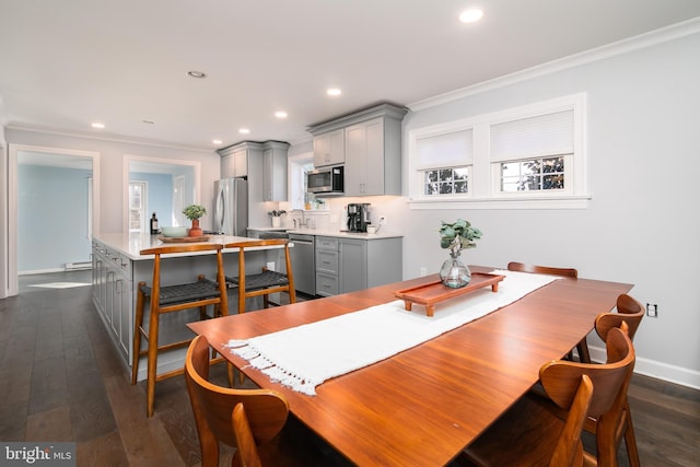 dining room featuring dark wood-style floors, recessed lighting, and crown molding