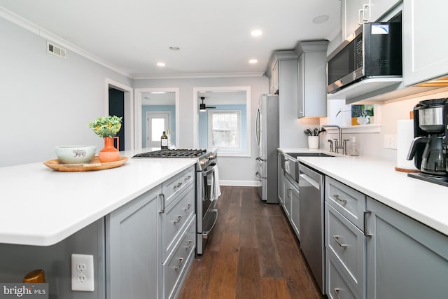 kitchen with stainless steel appliances, a sink, visible vents, light countertops, and gray cabinets